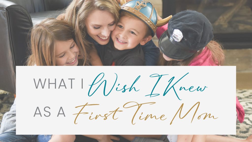 mom and three children laughing and hugging while reading a book.  What I wish I knew as a first-time mom, motherhood, parenting, mom life, Renewed Mama Coaching